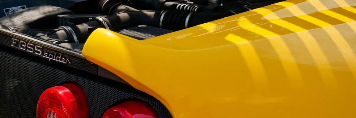 Detailed view of a yellow Ferrari F355 Spider at Noirmoutier-en-l'Île, ideal for automobile enthusiasts.
